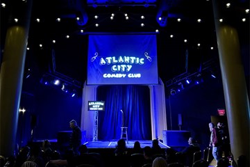 Atlantic City Comedy Club stage with sign, mic, and stool at Tropicana Atlantic City.