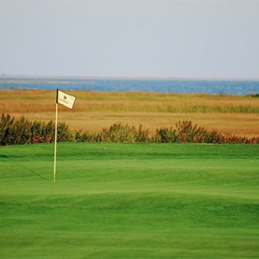 Seaview Bay Golf Course with water and wetlands nearby a green.
