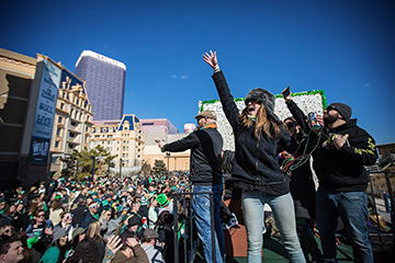 People standing on a float waving to crowd in front of Bally's and Caesarsat the annual St. Patrick's Day Parade on the Boardwalk.
