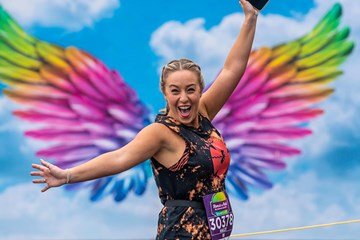 Woman spreads her wings at a Atlantic City race on the Boardwalk.