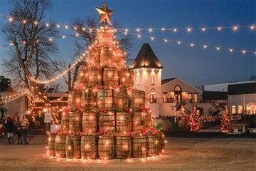 Renault Winery barrel holiday tree lit up in courtyard.