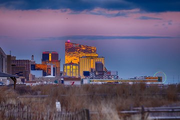 Golden Hour with Casino Resorts lit up along the Boardwalk in Atlantic City.