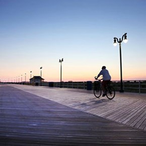 Bike rider at sunrise on the Atlantic City Boardwalk