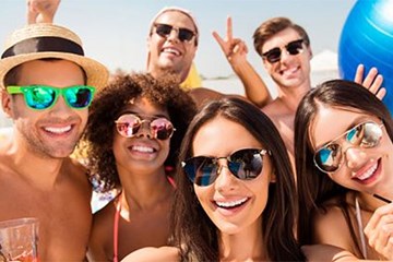 Resorts Casino with young people in summer attire and sunglasses smiling.
