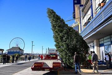 Showboat Hotel lifting Holiday Tree to Facade on the Atlantic City Boardwalk with Steel Pier the Wheel in view.