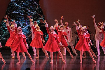 AC Ballet dancers dressed in santa hats and suits performing on stage at Caesars Atlantic City.