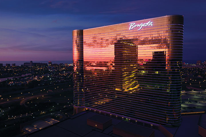 Borgata Casino Hotel tower reflects in sunset colors over Atlantic City.