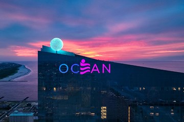 The top of Ocean Casino Resort with sign and iconic ball pictured just before sunrise over the Atlantic Ocean.