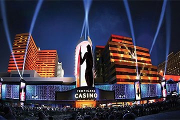 Tropicana Casino Resort Atlantic City lit up at night from Boardwalk.